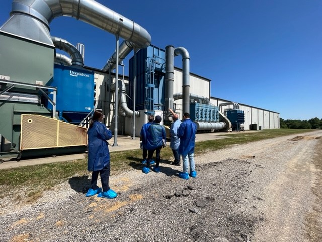 Five people in front of a facility 